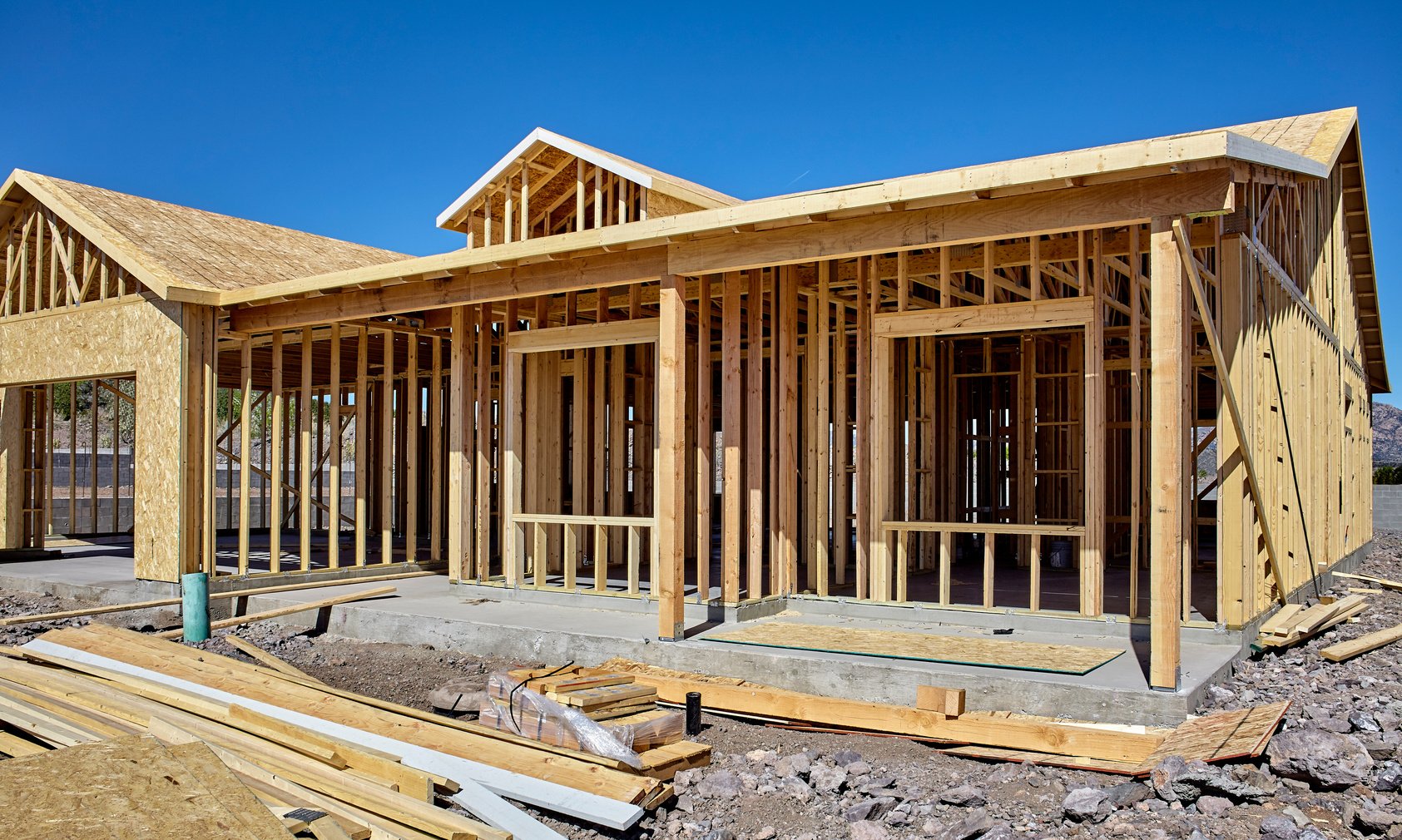 A house under construction with wooden framing. 