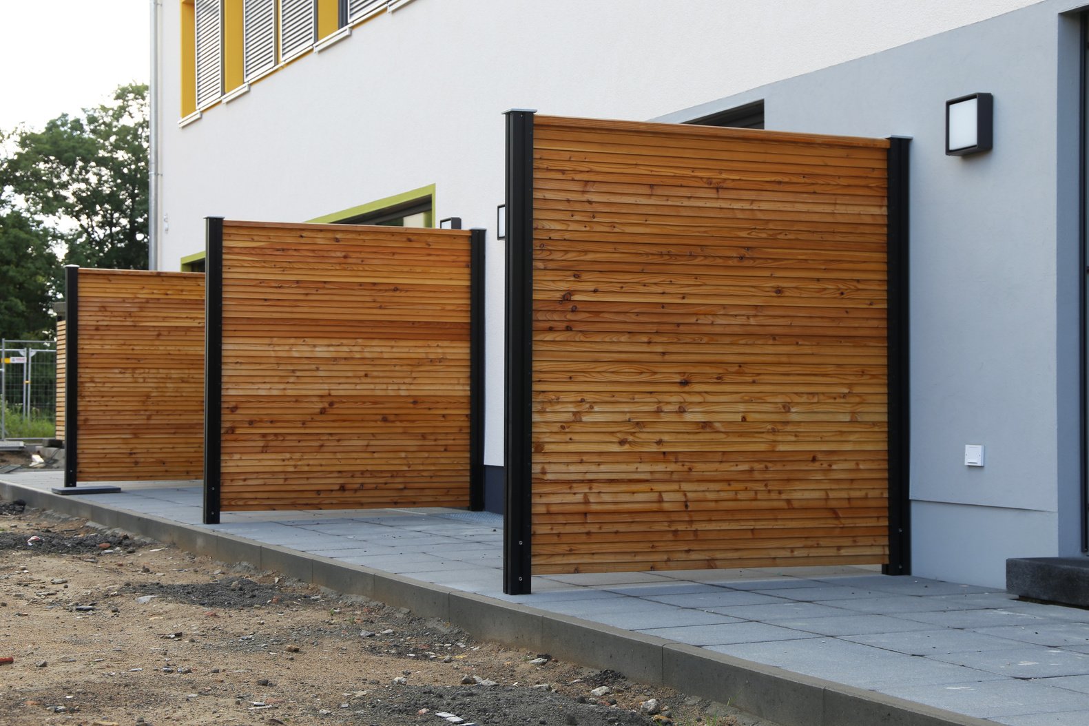 A wooden privacy fence between two units in a fourplex. 